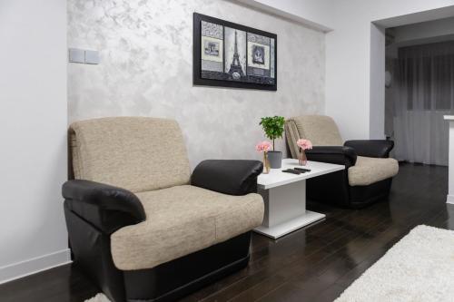 a waiting room with two chairs and a table at Exclusive Apartment in Giurgiu