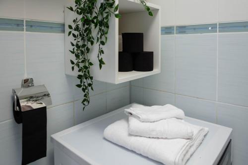 a bathroom with a white tub with towels on it at Exclusive Apartment in Giurgiu