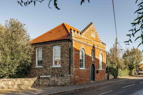 an old brick building on the side of a street at Host & Stay - The Chapel in Thornham in Thornham