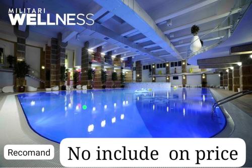 a large swimming pool in a hotel with the words no include on price at Suit apartment free parking in Roşu
