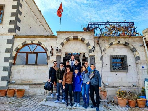 a group of people standing in front of a building at Muskara Cave Hotel in Göreme