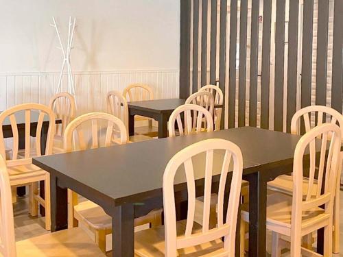 a dining room with two tables and wooden chairs at Apartamentos Midi 3000 in Formigal