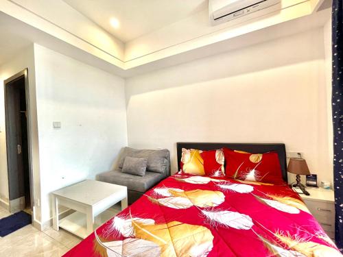 a bedroom with a bed and a chair at Prince Golden Bay Sihanoukville in Sihanoukville