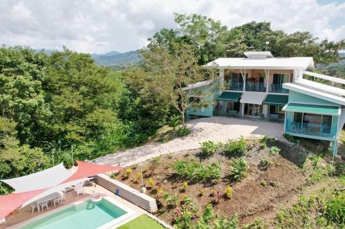 an aerial view of a house with a swimming pool at Boutique Tropical Retreat, Sleeps 10, Perfect for Friends and Fams in Sámara