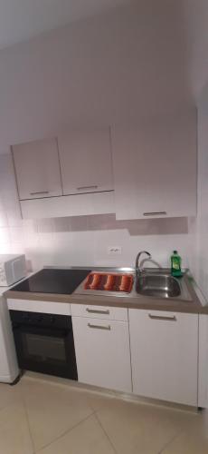 a small kitchen with a sink and a stove at Casa Minù in La Spezia