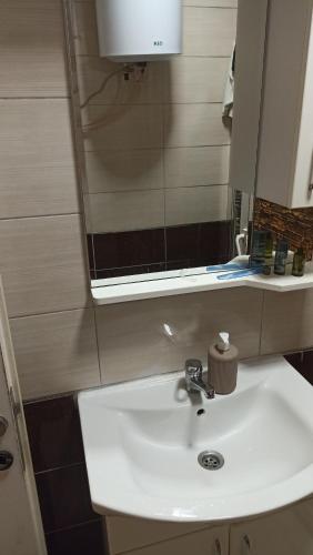 a bathroom with a sink and a mirror at Sky hostel in Pristina