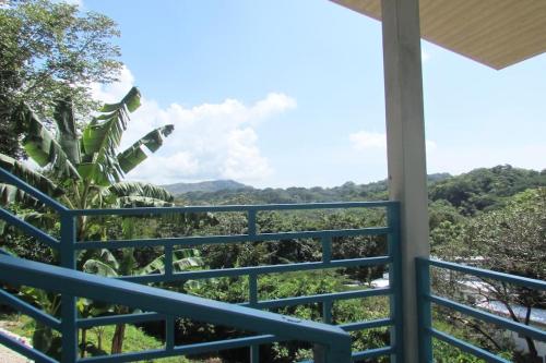 a view from the balcony of a house with a blue railing at Boutique Tropical Retreat, Sleeps 10, Perfect for Friends and Fams in Sámara