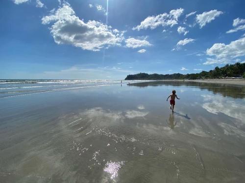 a person walking on the beach at Boutique Tropical Retreat, Sleeps 10, Perfect for Friends and Fams in Sámara