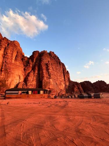 a group of benches in front of a mountain at Magic Bedouin Night in Wadi Rum