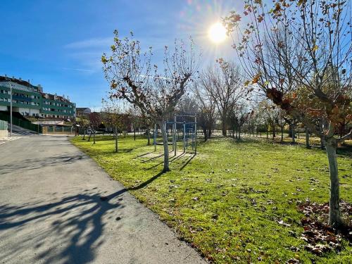 a park with a basketball hoop in the grass at Apartamento Entero 2 HABITACIONES in León