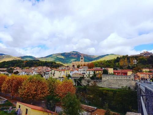 a view of a city with mountains in the background at Hotel Restaurant Le Costabonne in Prats-de-Mollo-la-Preste