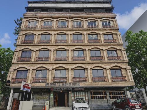 a tall building with a sign on it at Townhouse OAK Hotel Belsons Taj Mahal in Hyderabad