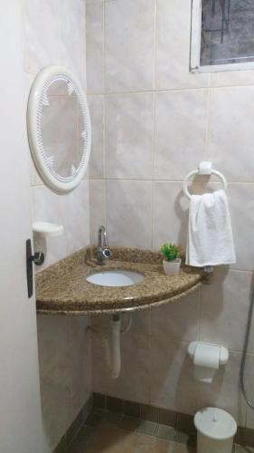 a bathroom with a sink and a mirror at Casa com ar condicionado in Lauro de Freitas