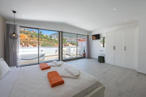 a bedroom with a large bed with orange pillows on it at Charming 3bed villa w/ pool, very close to centre in Kas