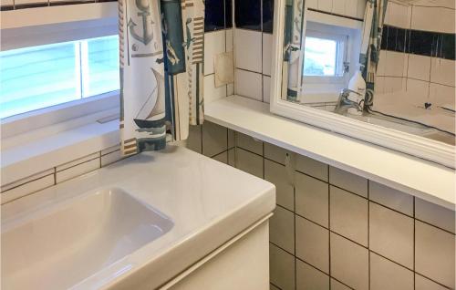 a white bathroom with a sink and a window at 4 Bedroom Cozy Home In Stavang in Stavang