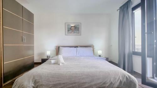 a bedroom with a large bed with two towels on it at Room Fiore in Novigrad Istria