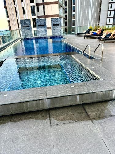 a swimming pool on the side of a building at Apartment Serenity Wongamat in North Pattaya