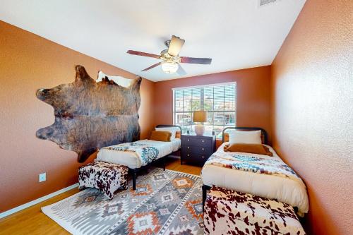 a bedroom with two beds and a ceiling fan at Desert Dream in Cave Creek