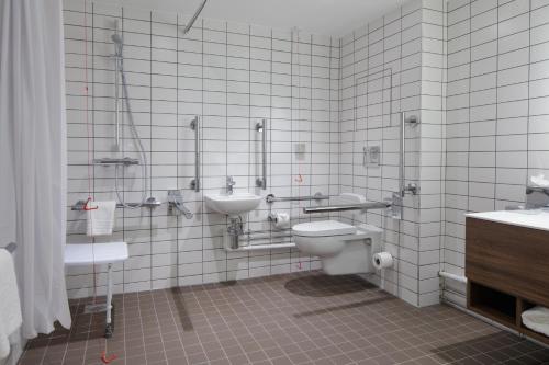a bathroom with a toilet and a sink at Hilton Garden Inn Stoke On Trent in Stoke on Trent