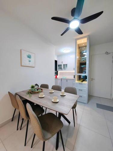 a dining room table with chairs and a ceiling fan at Maxim Majestic 3BR Connaught MRT in Kuala Lumpur