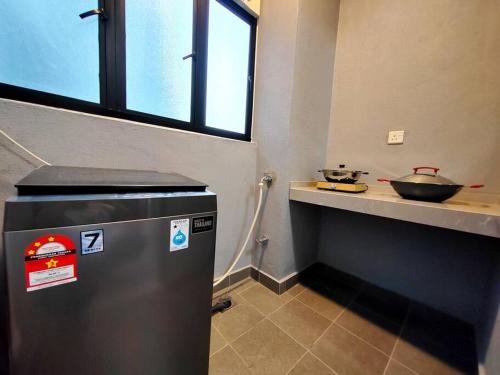 a small kitchen with a counter and a stove at Maxim Majestic 3BR Connaught MRT in Kuala Lumpur