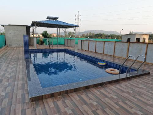 a swimming pool on the roof of a house at Hotel Sandesh Palace Lonavala in Lonavala