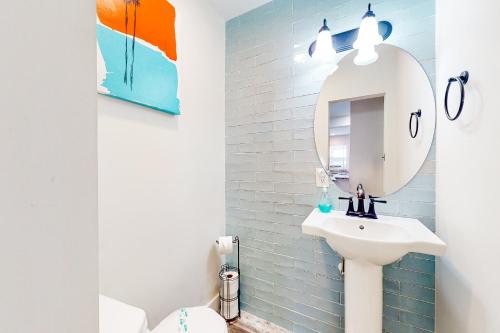 a bathroom with a white sink and a mirror at Town of Rehoboth Beach --- 20485 Lincoln St. Unit 2 in Rehoboth Beach