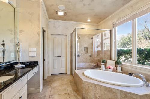 a bathroom with a large tub and a large window at Stunning Lakefront Retreat Pool Boat Lift Spectacular Views in Horseshoe Bay