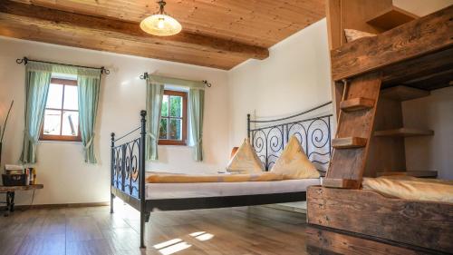 a bedroom with two beds in a room with wooden ceilings at Die Steirakeischn in Großklein