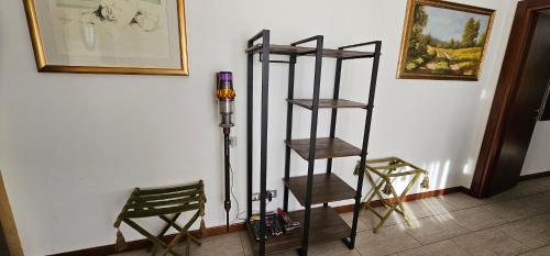 a room with three shelves and two chairs at Milan Condo ideal for Families,Pets,Business in Milan