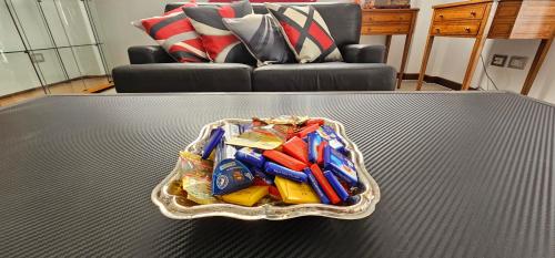 a bowl of candy on a table in a living room at Milan Condo ideal for Families,Pets,Business in Milan