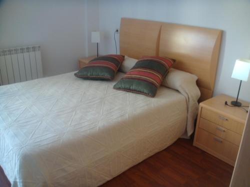 a bedroom with a bed with two pillows on it at EL RINCÓN del TOLOÑO in Haro
