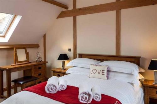 a bedroom with a bed with towels on it at Trefaen Cottage in Brecon