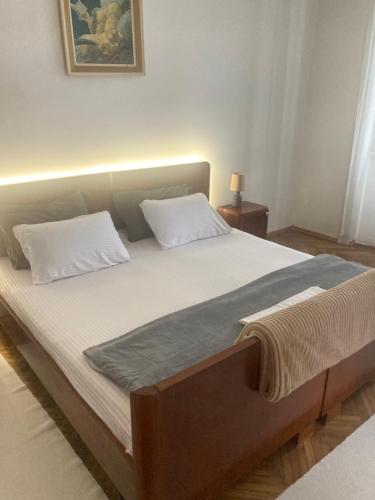 a bed with two pillows on it in a bedroom at Plaža Stari Grad Budva pjena od mora Beach Apartman in Budva