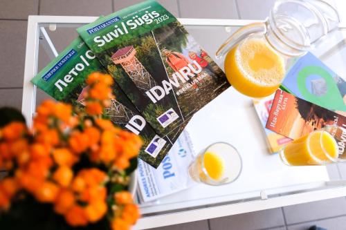 an open refrigerator with a magazine and a glass of orange juice at Hostel Nele in Jõhvi