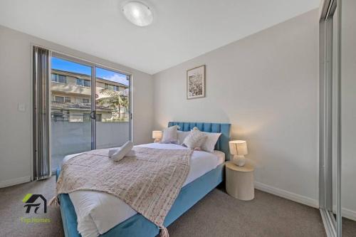 a bedroom with a bed and a large window at Entire apartment in Hornsby in Hornsby