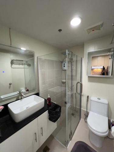 a bathroom with a sink and a shower and a toilet at Brenthill Baguio condo unit near SM baguio in Baguio