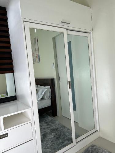a large mirror in a room with a bedroom at Brenthill Baguio condo unit near SM baguio in Baguio
