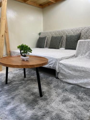 a living room with a couch and a table at Brenthill Baguio condo unit near SM baguio in Baguio