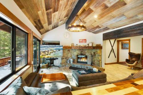 a living room with a couch and a fireplace at Luna Cabin - 5BR Hot Tub A/C Game Room EV Charger in Tahoe Vista