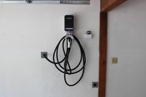 a cell phone is hanging on a wall at Luna Cabin - 5BR Hot Tub A/C Game Room EV Charger in Tahoe Vista