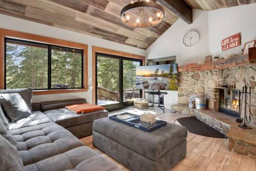 a living room with a couch and a fireplace at Luna Cabin - 5BR Hot Tub A/C Game Room EV Charger in Tahoe Vista