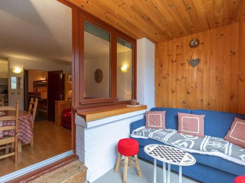 un salon avec un canapé bleu et une table dans l'établissement Agréable Studio pour 5 avec balcon exposé sud à La Mongie - FR-1-404-346, à La Mongie