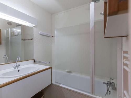 a white bathroom with a shower and a sink at Appartement La Mongie, 1 pièce, 4 personnes - FR-1-404-348 in Bagnères-de-Bigorre