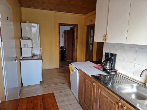 a kitchen with a white refrigerator and a sink at Püha Guesthouse in Püha