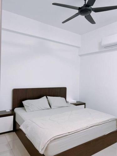a bedroom with a bed with a ceiling fan at 5D Homestay in Sitiawan