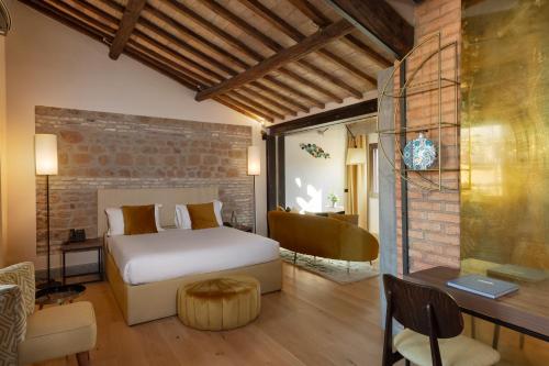 a bedroom with a bed and a desk in a room at Passpartout Boutique Palace in Rome