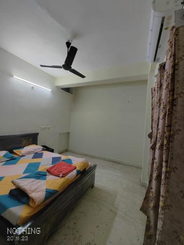 a bedroom with a bed and a ceiling fan at S A Villa in Hyderabad