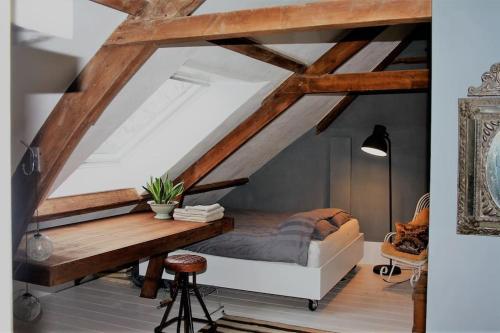 a bedroom with a bed and a wooden table at Farmhouse bohemian style close to Amsterdam in Waverveen