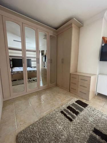 a room with a bedroom with a closet and a rug at Beautiful New Apartment with Garden in Sunny lakes Resort in Sharm El Sheikh